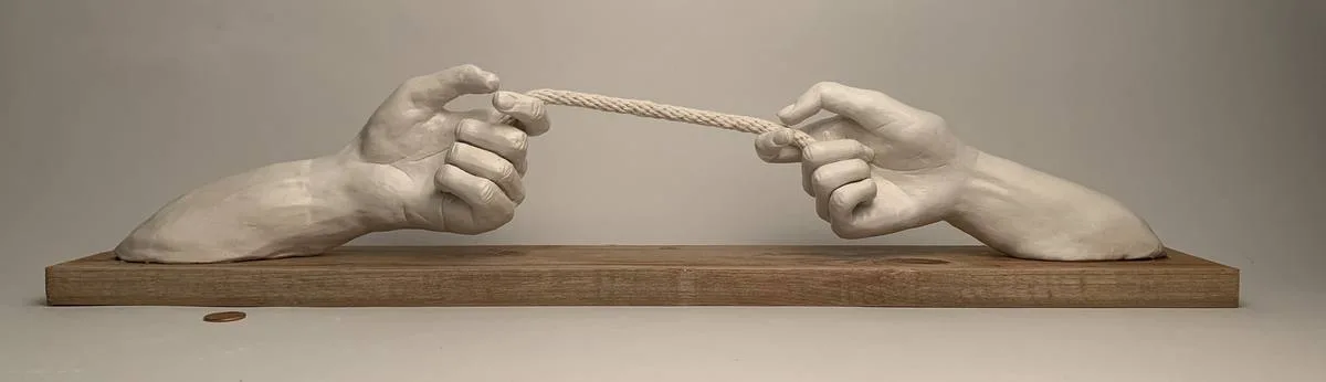 Sculpted hands holding a rope